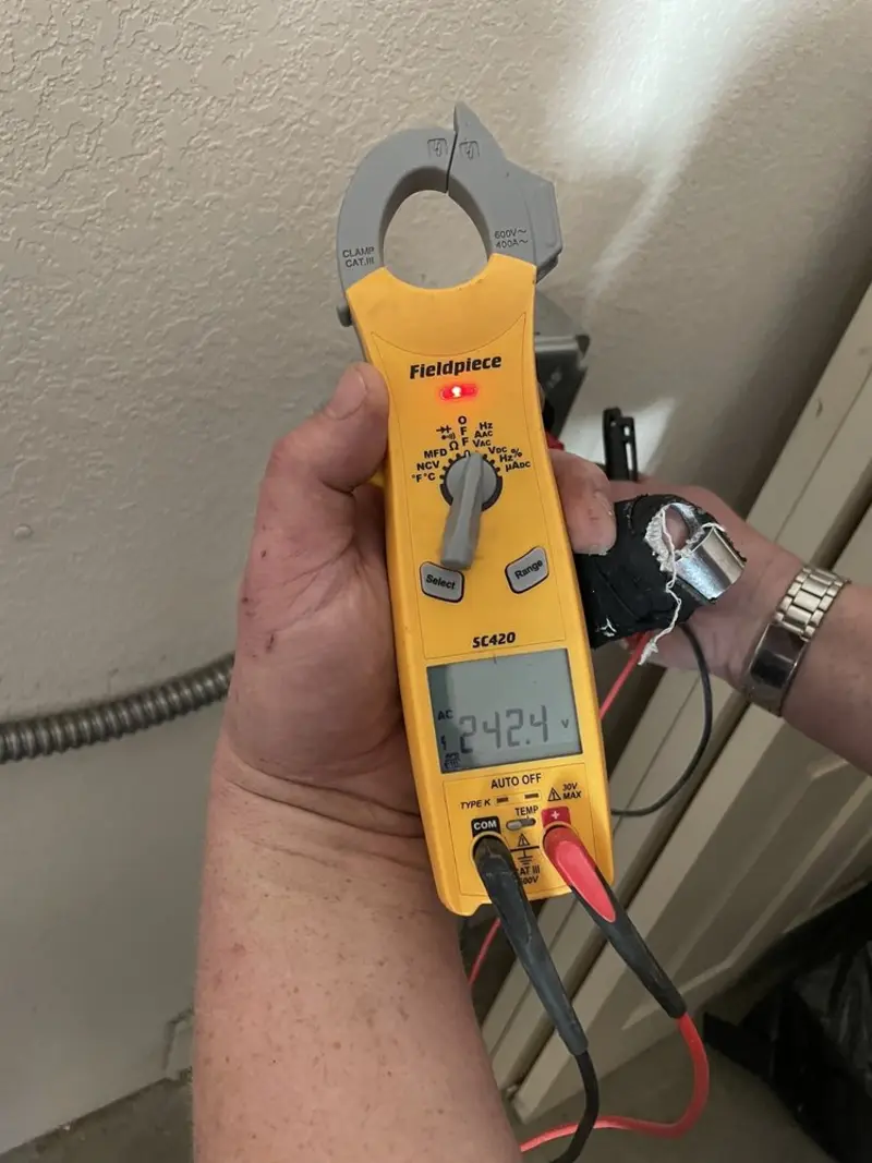 Voltage testing with clamp meter during Recessed Lighting Installation in Corinth